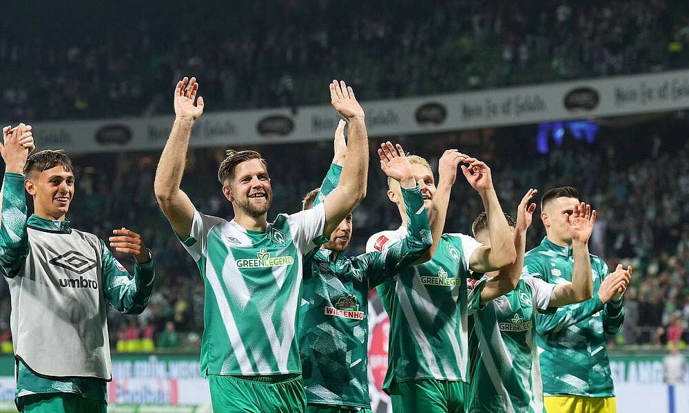 Werder players celebrate their win with the fans