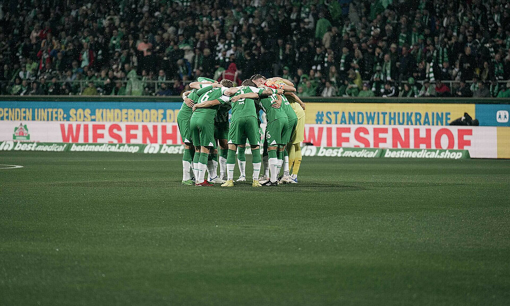 The players in a huddle before the game against Gladbach kicked off.