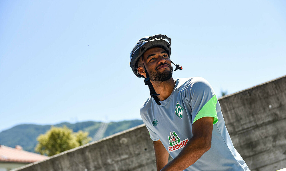 Manuel Mbom wearing a bike helmet at the training camp.