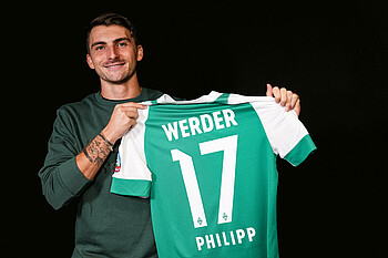 Maximilian Philipp holding his number 17 shirt.
