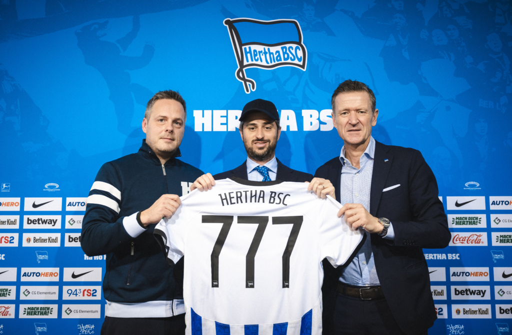 Kay Bernstein, Josh Wander and Thomas E. Herrich posing with a Hertha shirt.