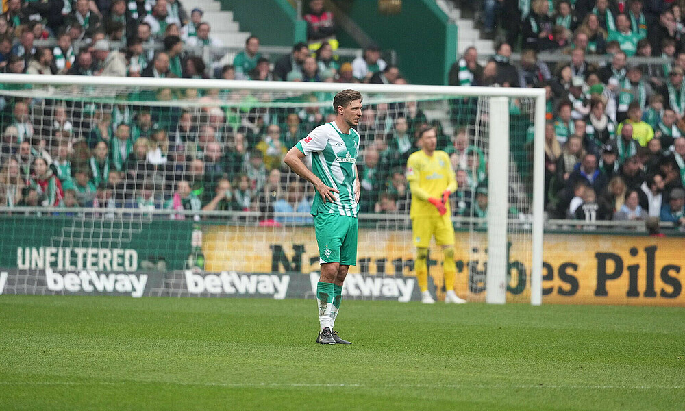 Niklas Stark standing downcast on the pitch.