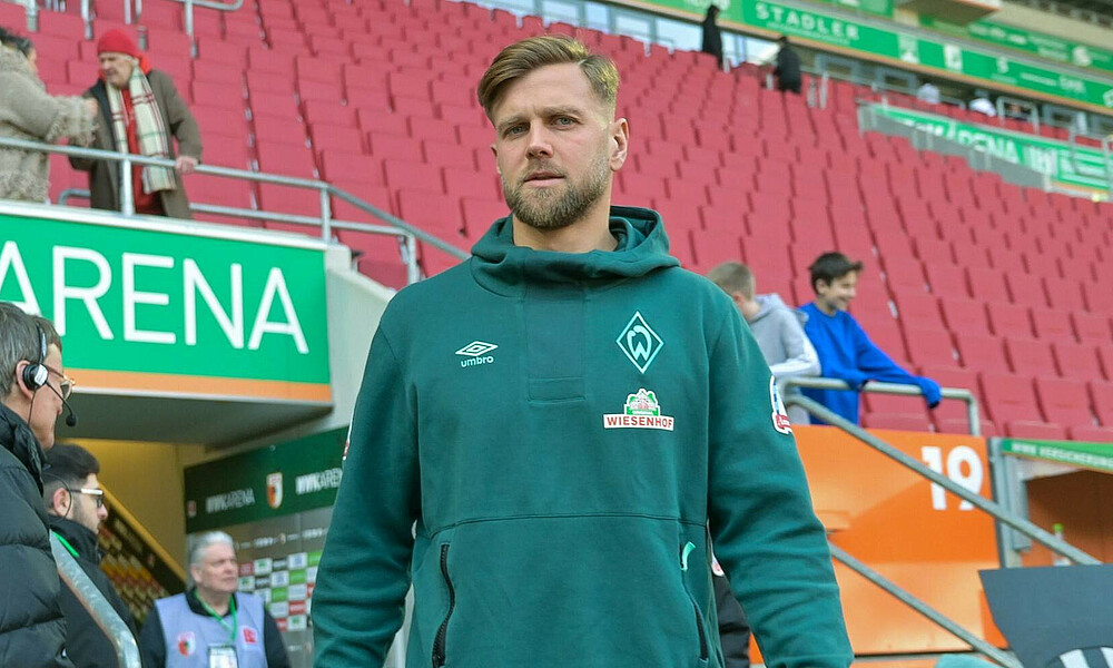 Niclas Füllkrug wearing a green hoodie.