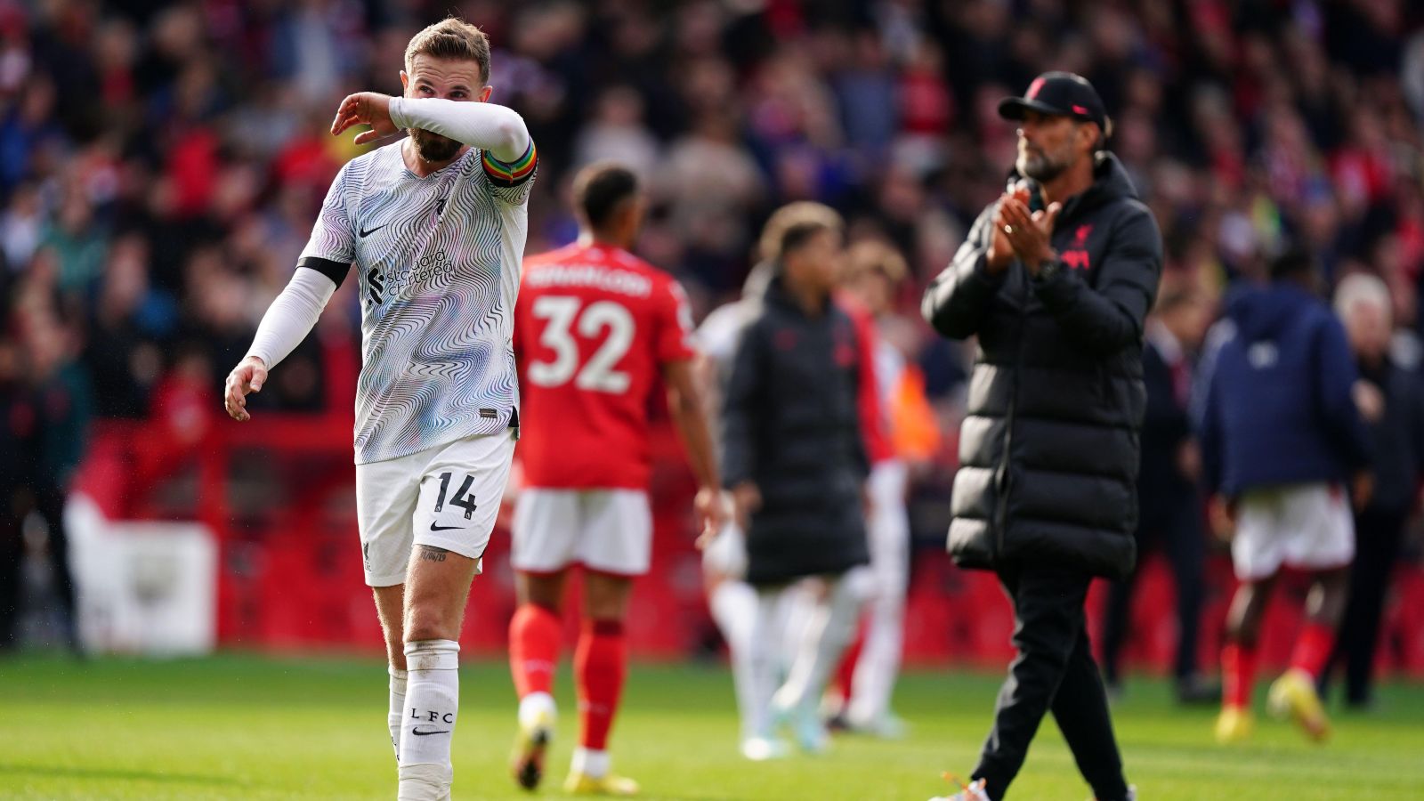Liverpool captain Jordan Henderson wipes his face with his arm