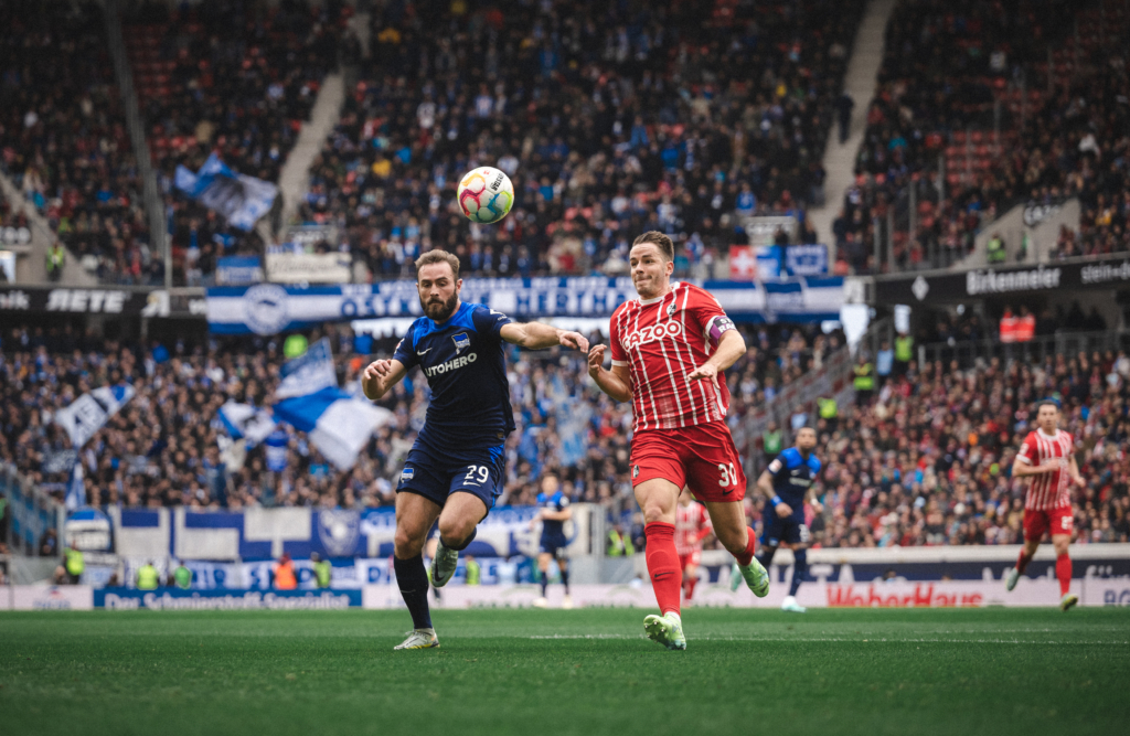 Lucas Tousart competes for the ball.