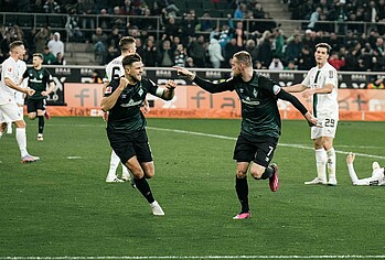 Marvin Ducksch pointing at Niclas Füllkrug as they run off to celebrate a goal.