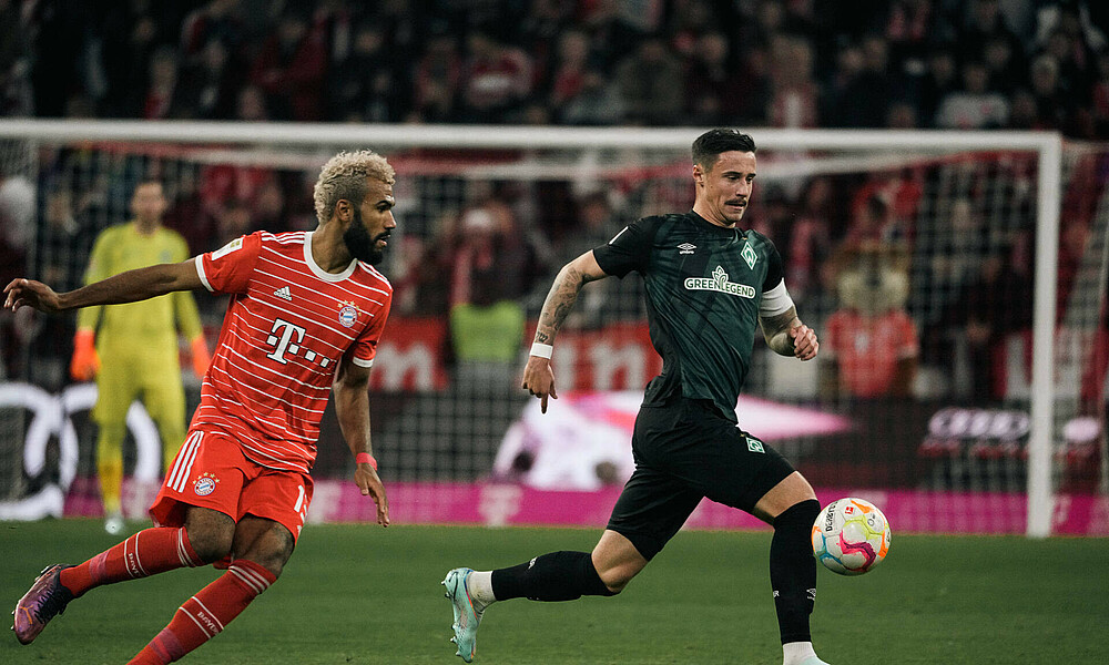 Marco Friedl in possession with Bayern's Eric Maxim Choupo-Moting giving chase