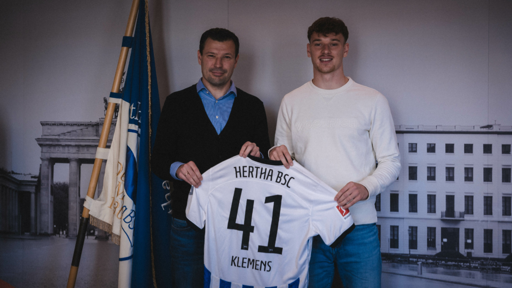 Pascal Klemens holds up his shirt alongside Benjamin Weber.