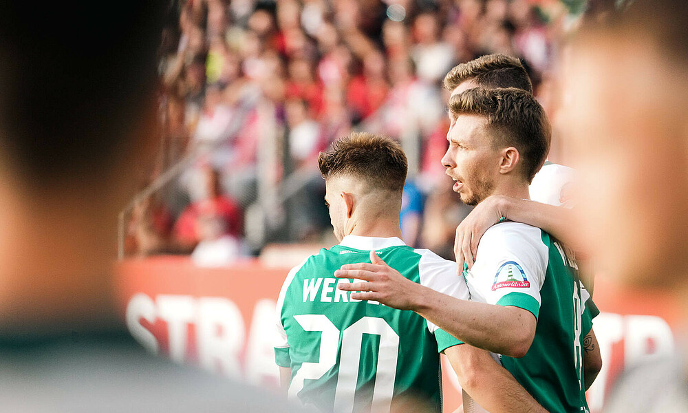 Weiser and Schmid celebrate a goal.