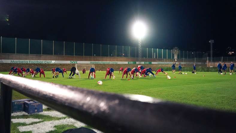 The team train under lights in the evening in Marbella.