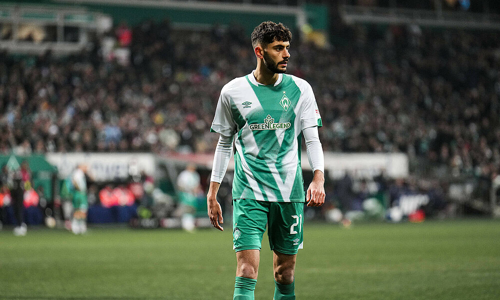 Eren Dinkci walking along the pitch during a game.