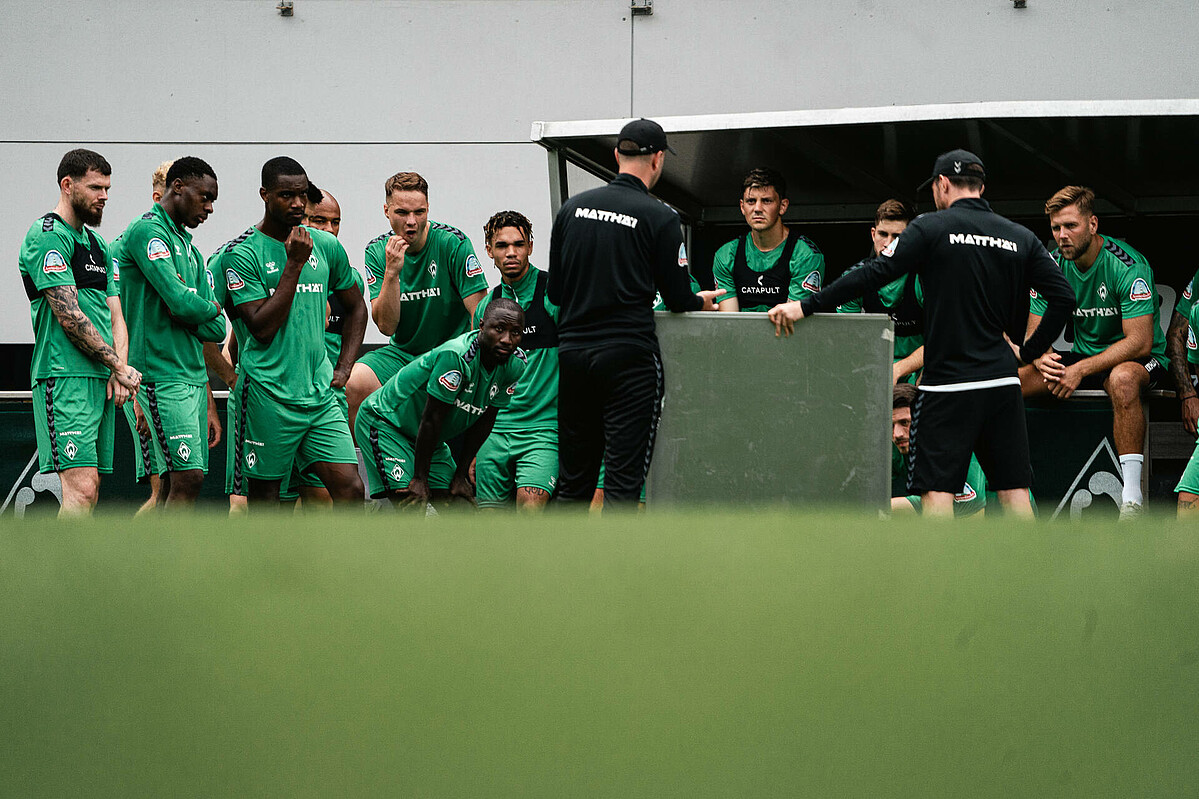 The players and coaches during a tactics session