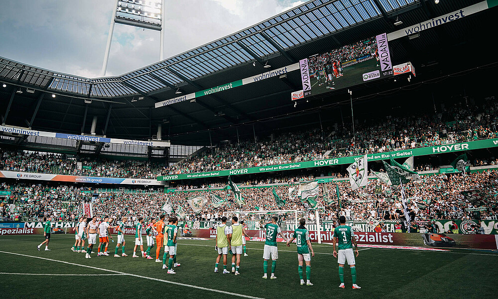 The team in front of the east stand after the match.