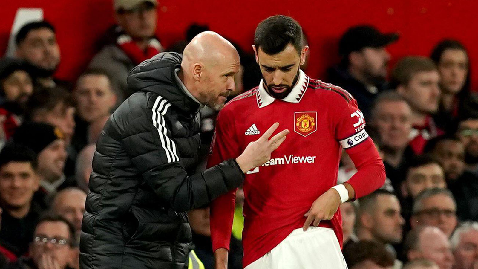 Manchester United manager Erik ten Hag speaks with Bruno Fernandes during the Emirates FA Cup third round match at Old Trafford, Manchester.