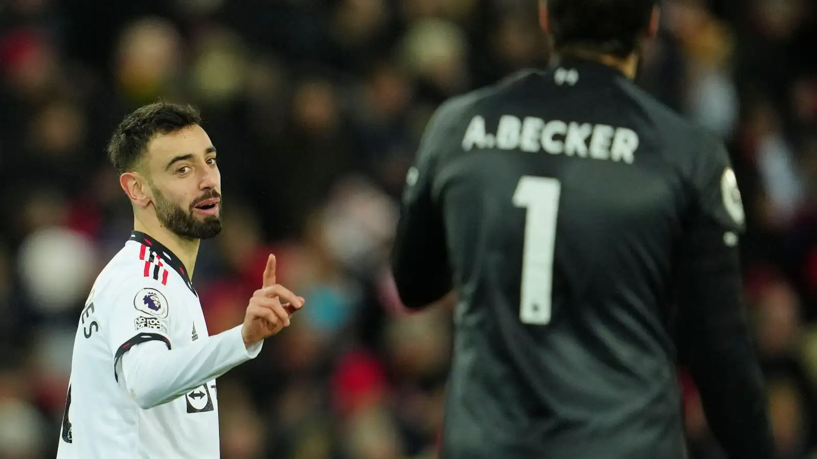 Man Utd midfielder Bruno Fernandes shakes his finger at Liverpool goalkeeper Alisson