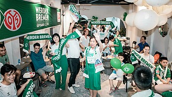 People dancing and cheering at the watch party in Hanoi.