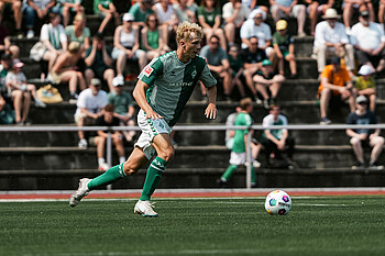 Leon Opitz running with the ball at his feet during a match.