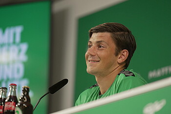 Dawid Kownacki smiles during the Mixed Zone.