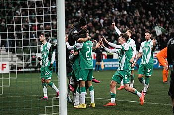 The players and staff celebrate last season's win against Wolfsburg.