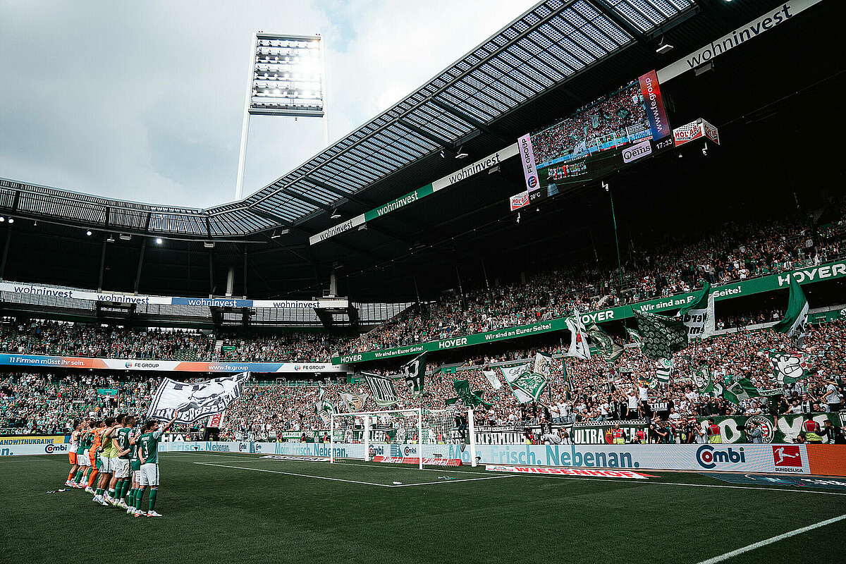 The team celebrating in front of the Ostkurve.