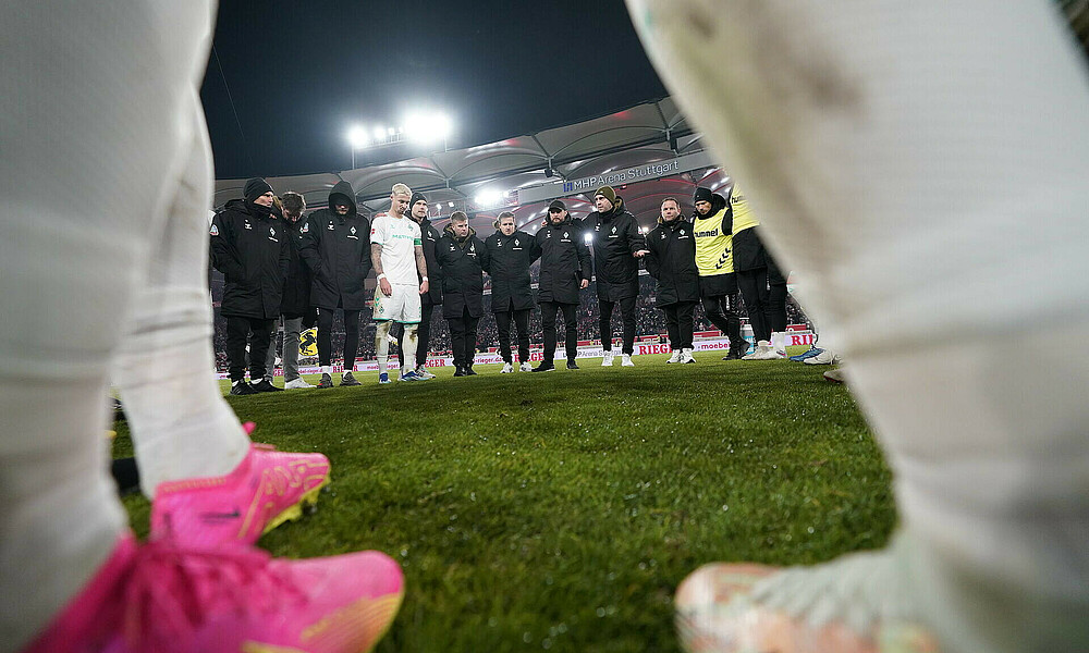 The team in a huddle after the game.