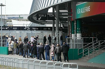 People lined up in front of the stadium.