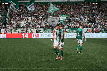 Marco Friedl on the pitch with his head down.