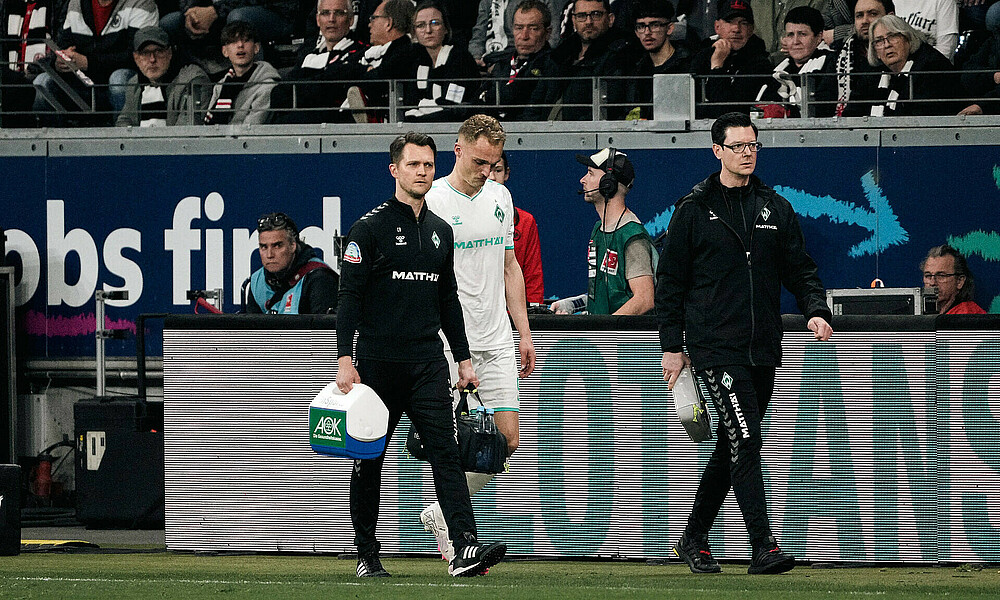 Amos Pieper leaving the pitch with the medic.