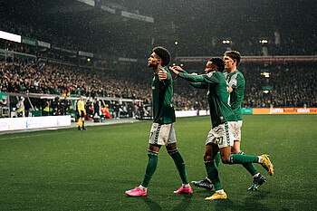 Justin Njinmah celebrates scoring alongside his teammates.