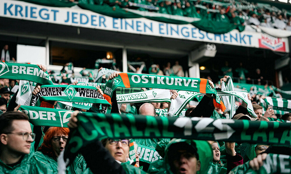 Werder fans holding their scarves in the air