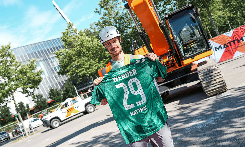 Marco Friedl holds up our new home shirt.