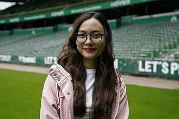 Schoolteacher Van Do smiles to the camera at the Weserstadion.