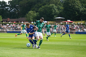 Oliver Burke challenging for the ball.