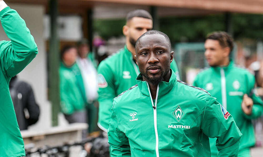 Naby Keita wearing a green training jacket.