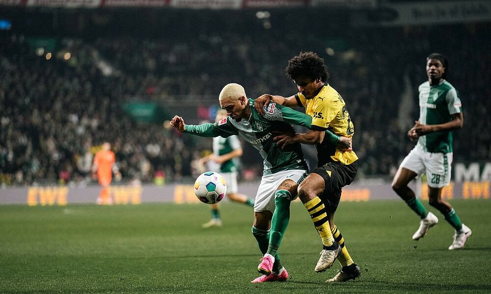 Njinmah battling for the ball against Karim Adeyemi.