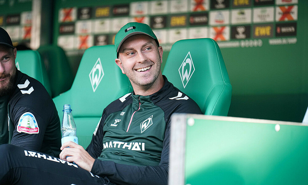 Ole Werner smiling in the dugout.