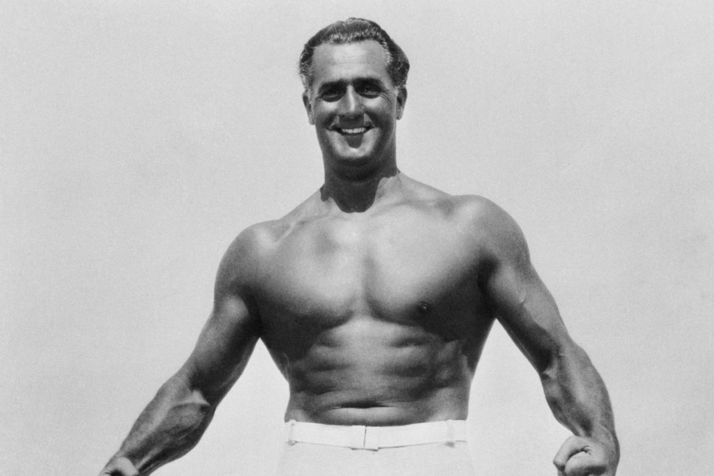 Charles Atlas Flexing Muscles on Beach